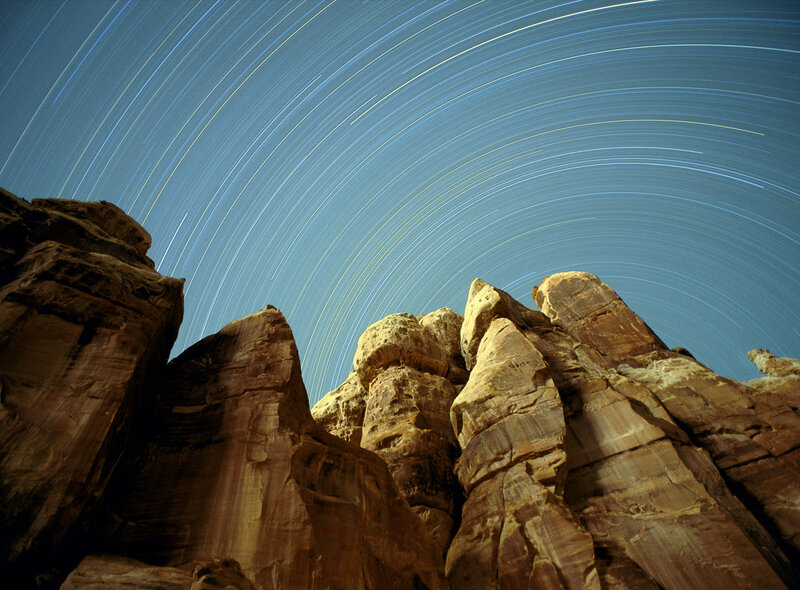 Star trails over rock formations