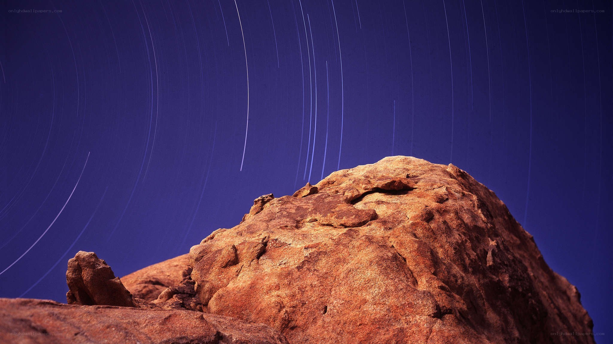 Star trails over rocky landscape