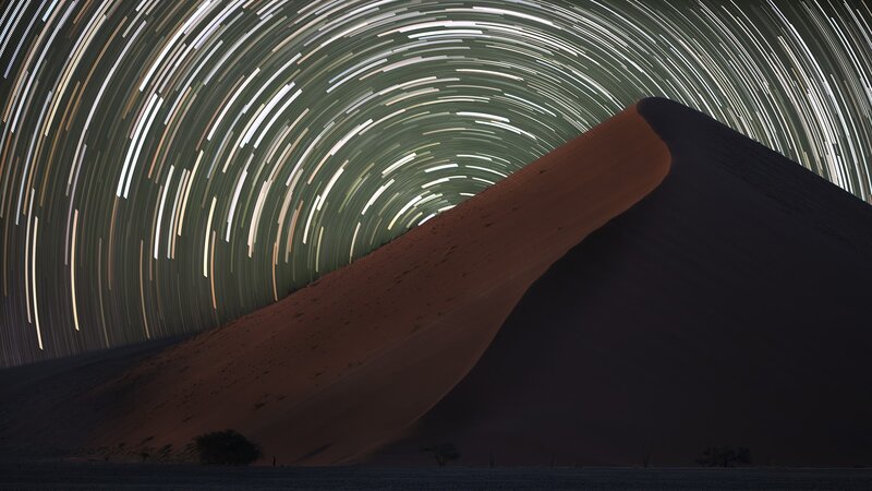 Star trails over sand dune