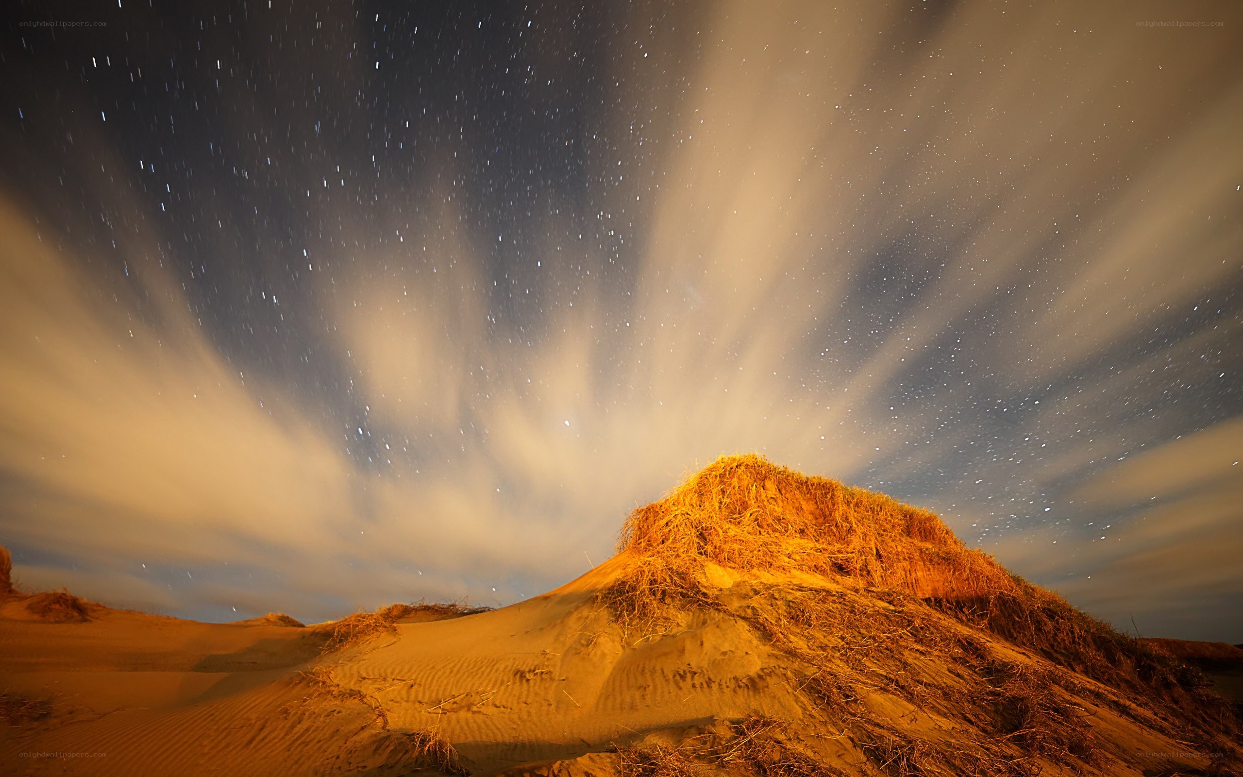 Star trails over sand dunes
