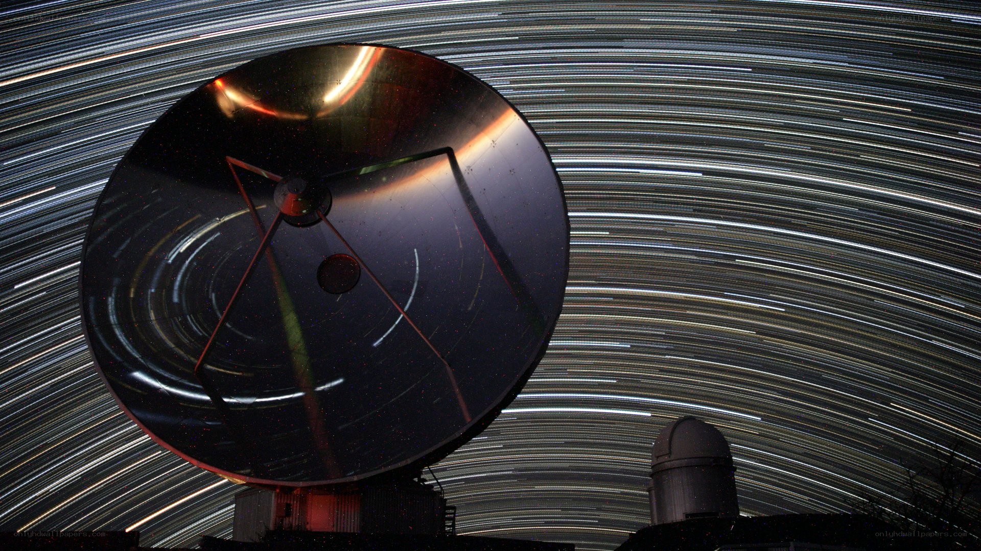 Star trails over satellite dish