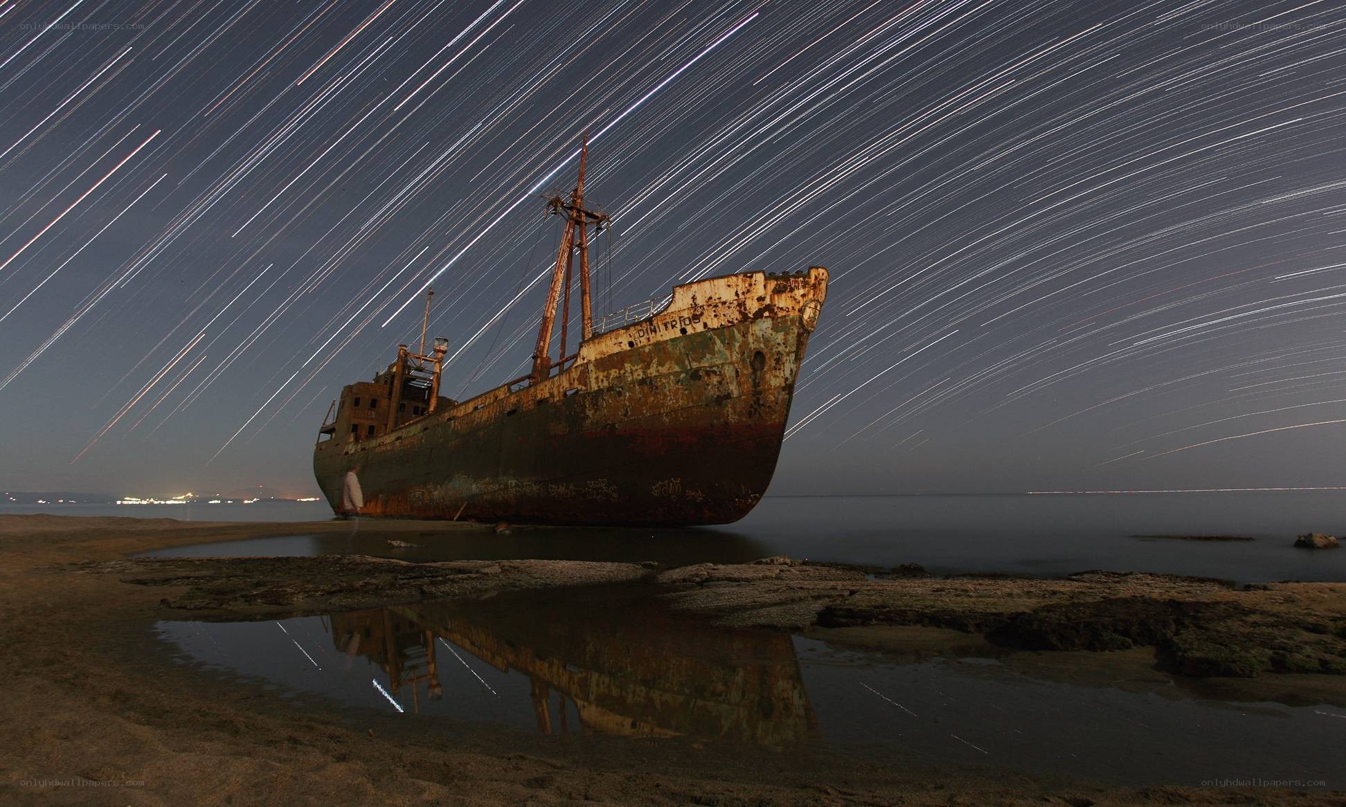 Star trails over shipwreck