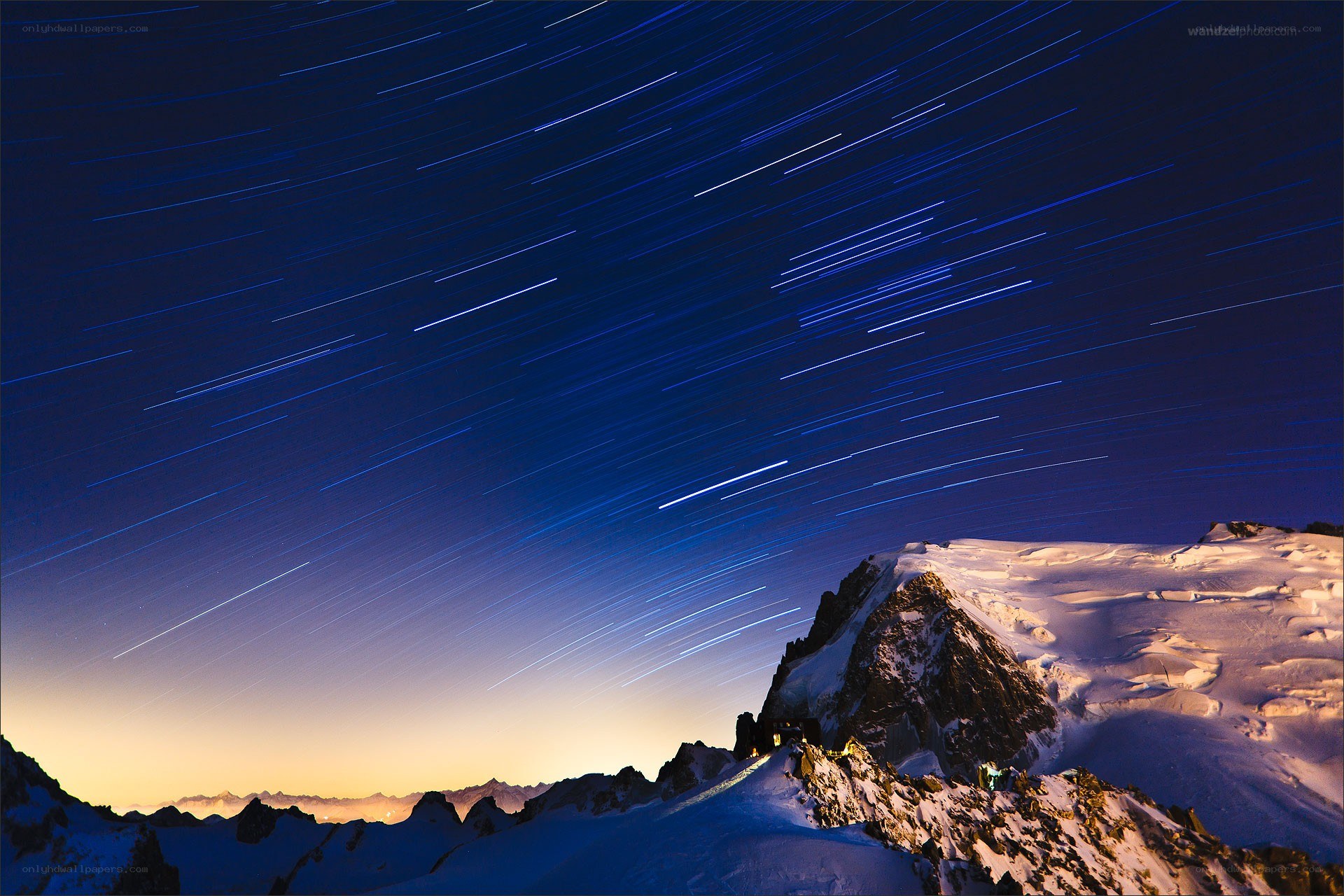 Star trails over snowy mountain