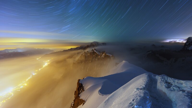 Star Trails over Snowy Peaks