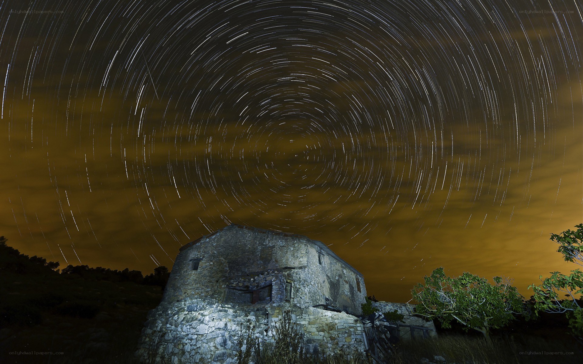 Star trails over stone building