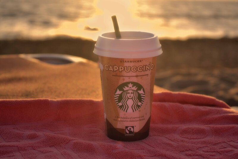 Starbucks cappuccino on beach