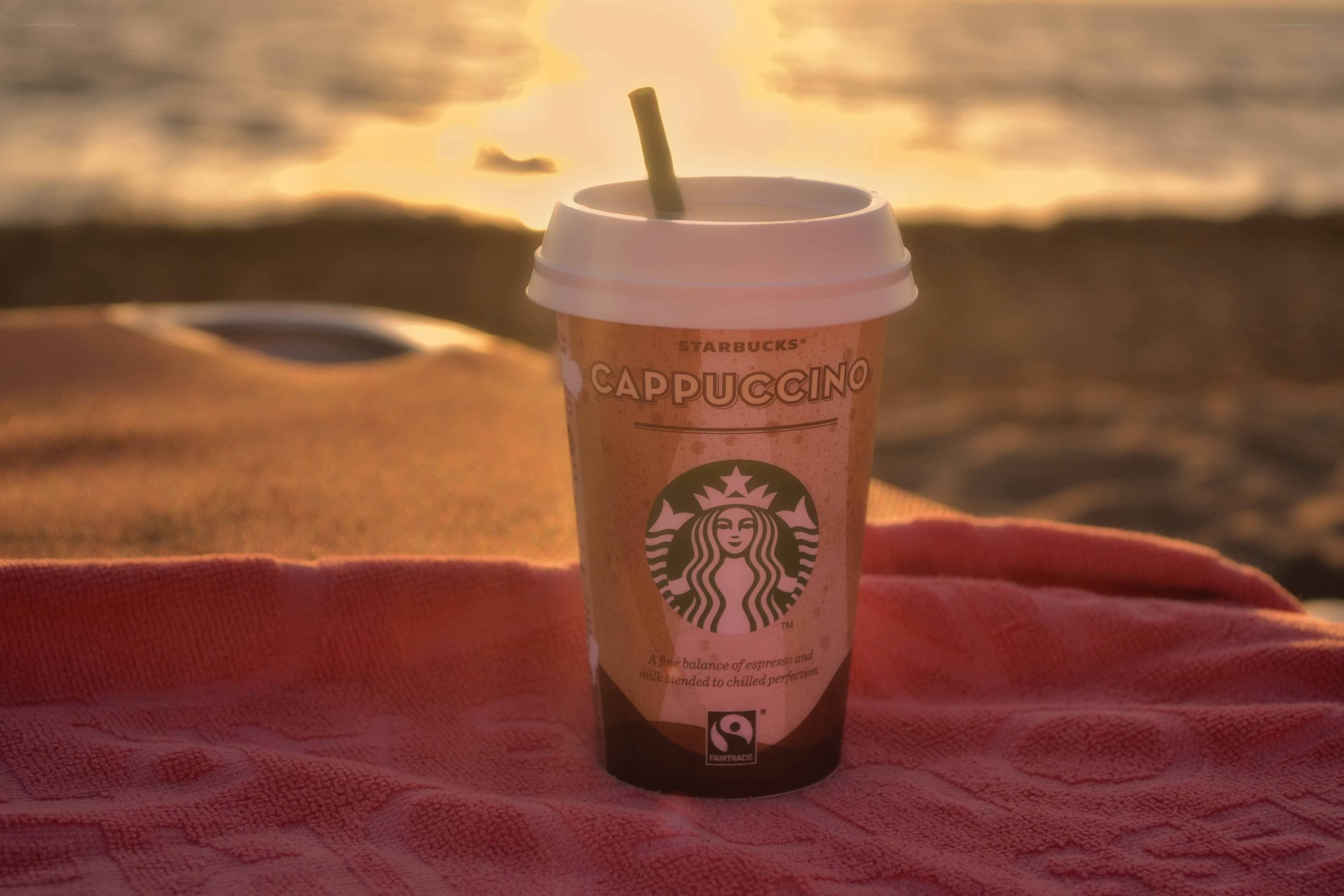 Starbucks cappuccino on beach