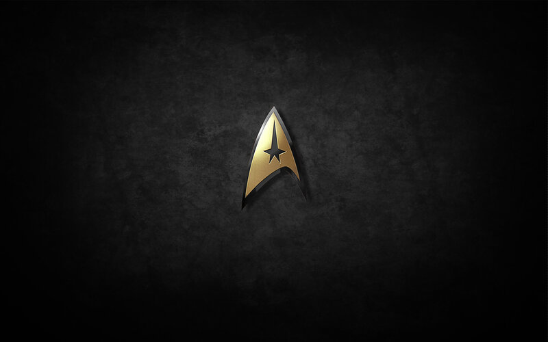 Starfleet insignia on dark background