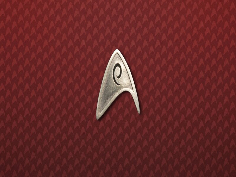 Starfleet insignia on red background