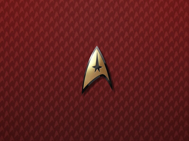 Starfleet insignia on red background