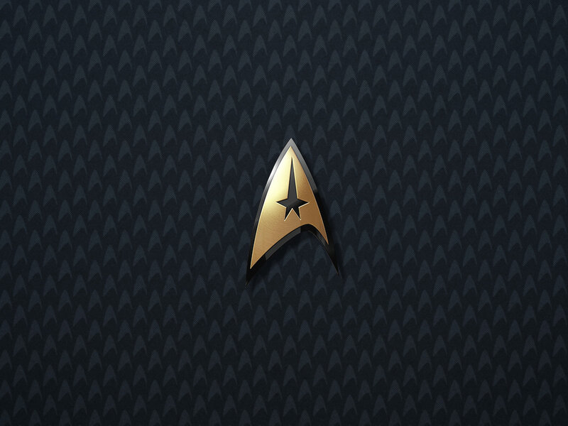 Starfleet insignia on textured background