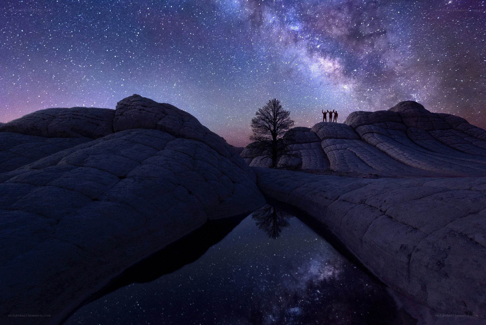 Stargazers on a rocky outcrop