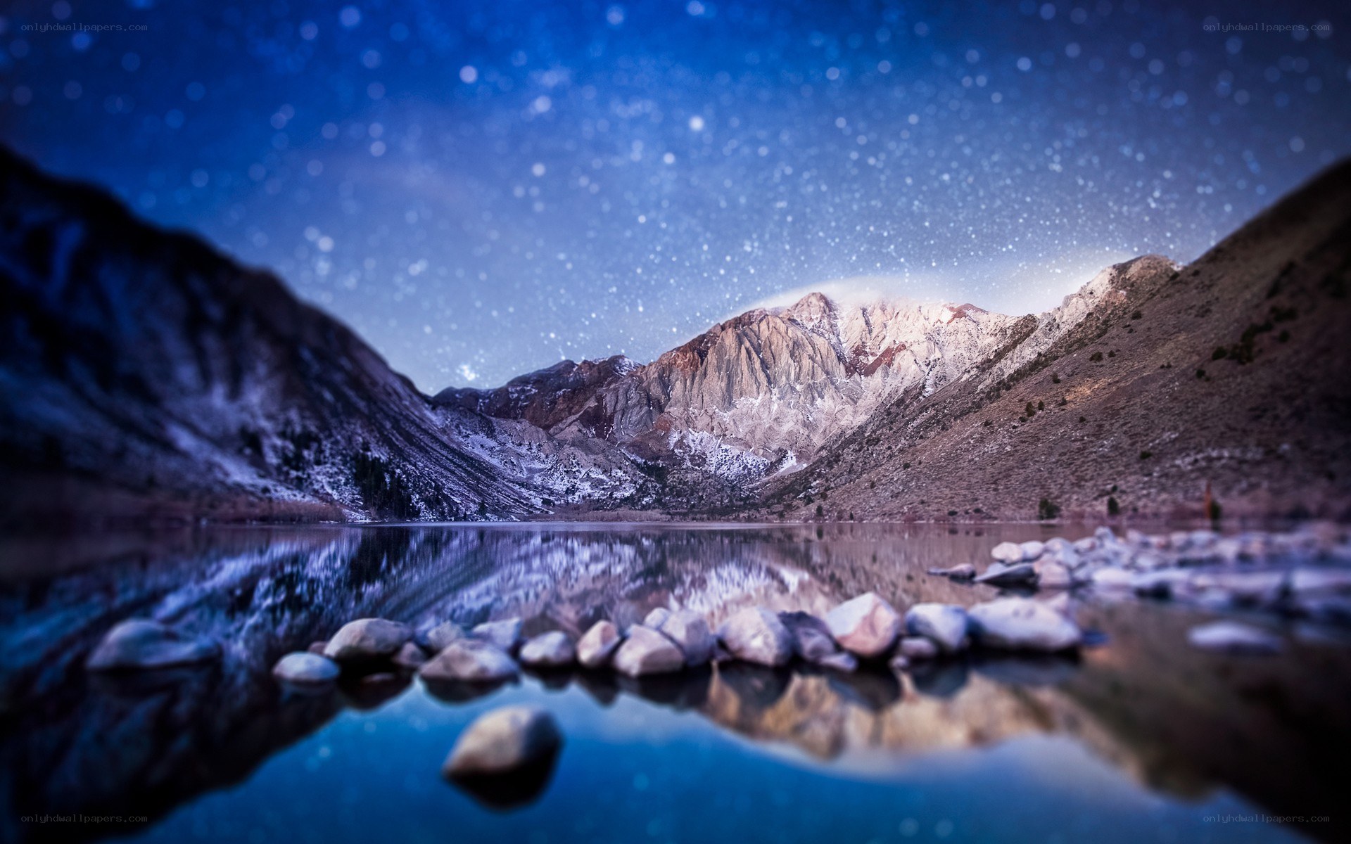 Starlit mountain lake at night