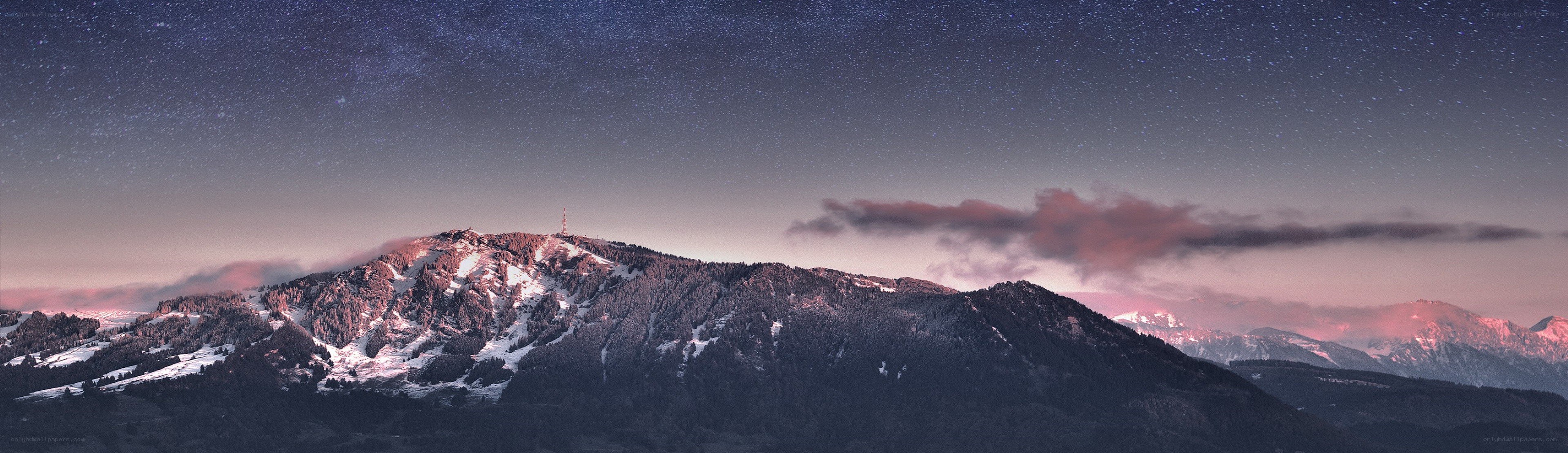 Starlit mountain peak at dusk