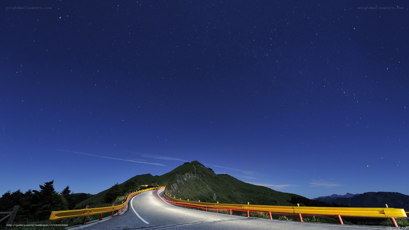 Starlit mountain road at night