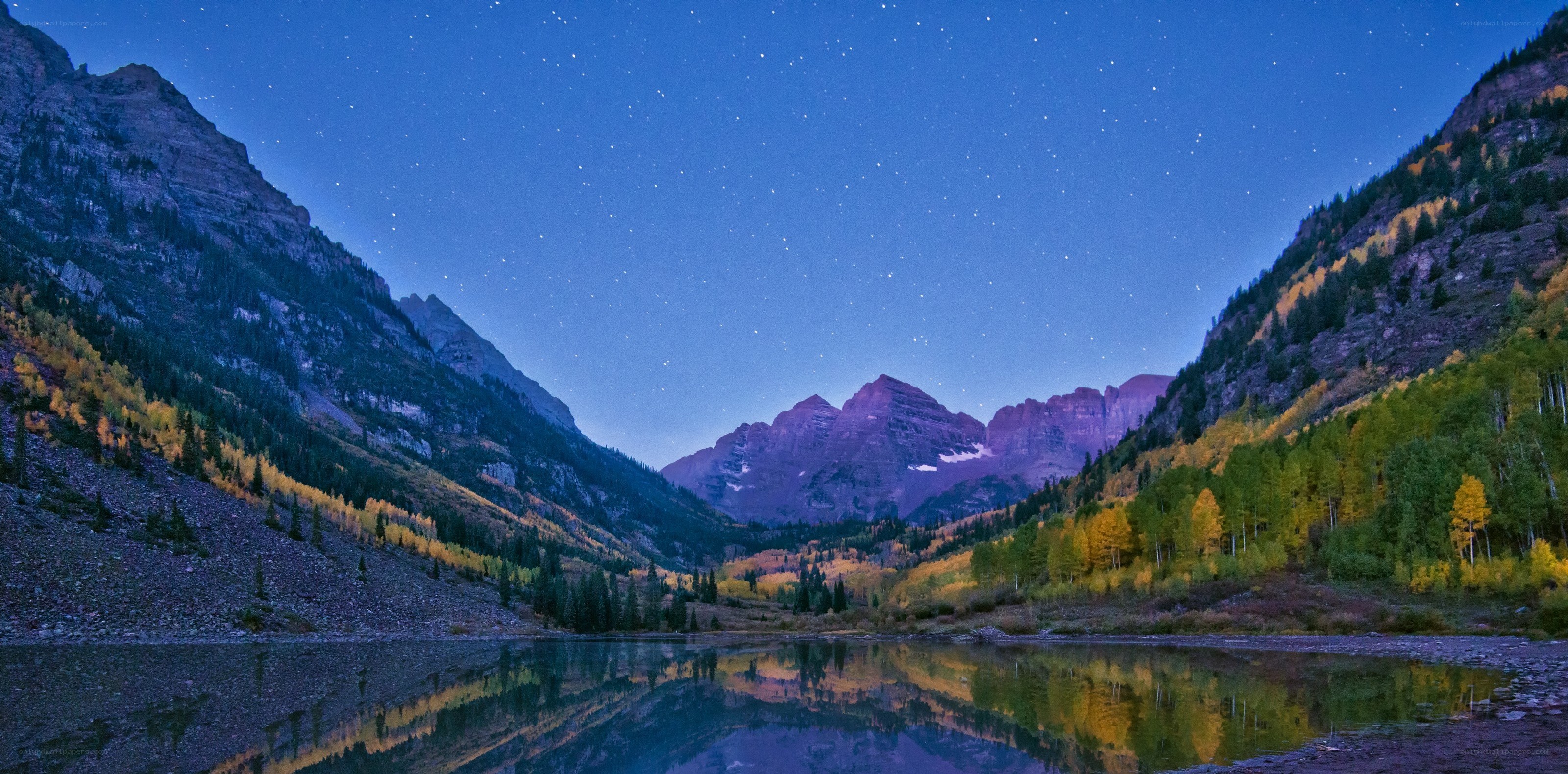Starlit mountains reflected in a lake