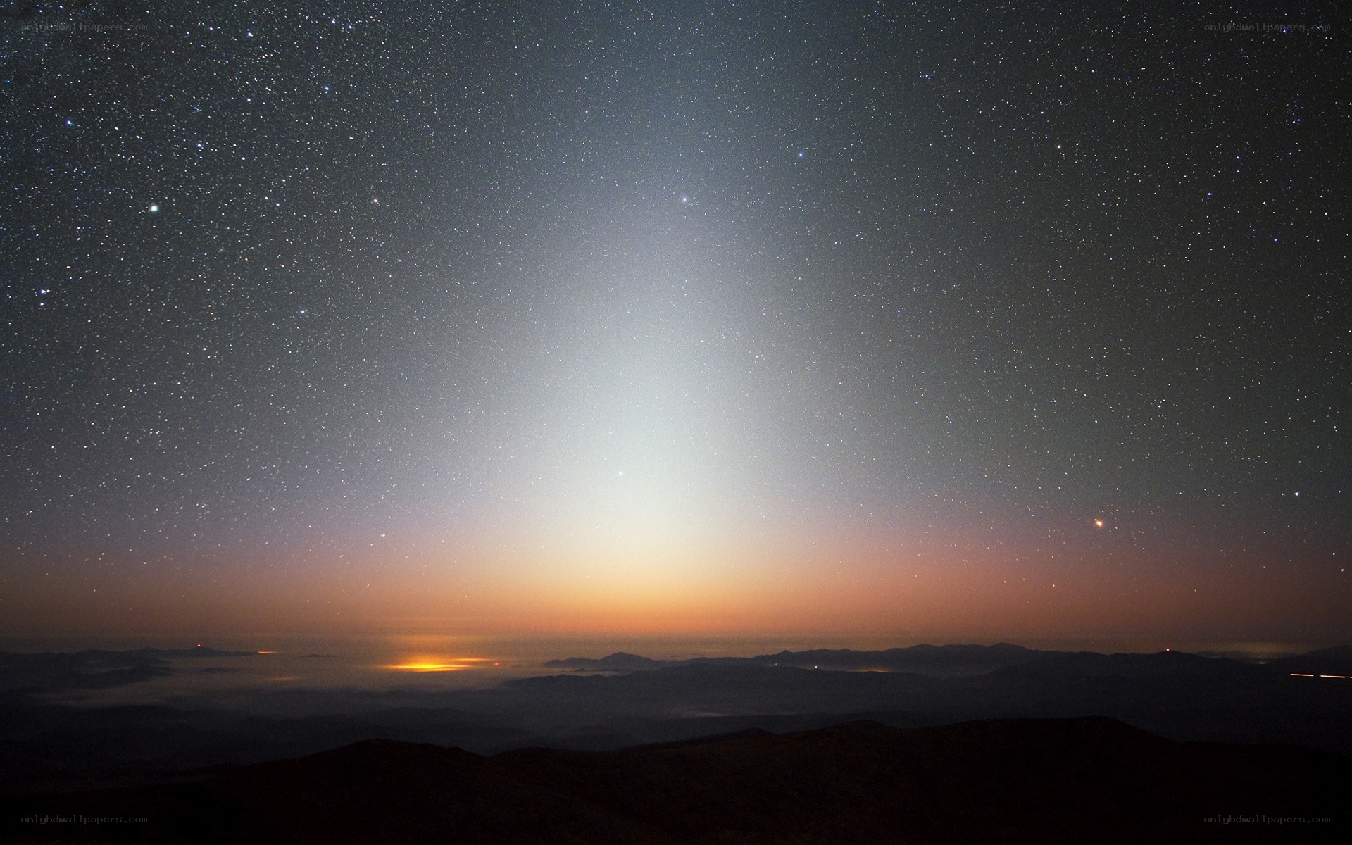 Starlit sky over mountain peaks