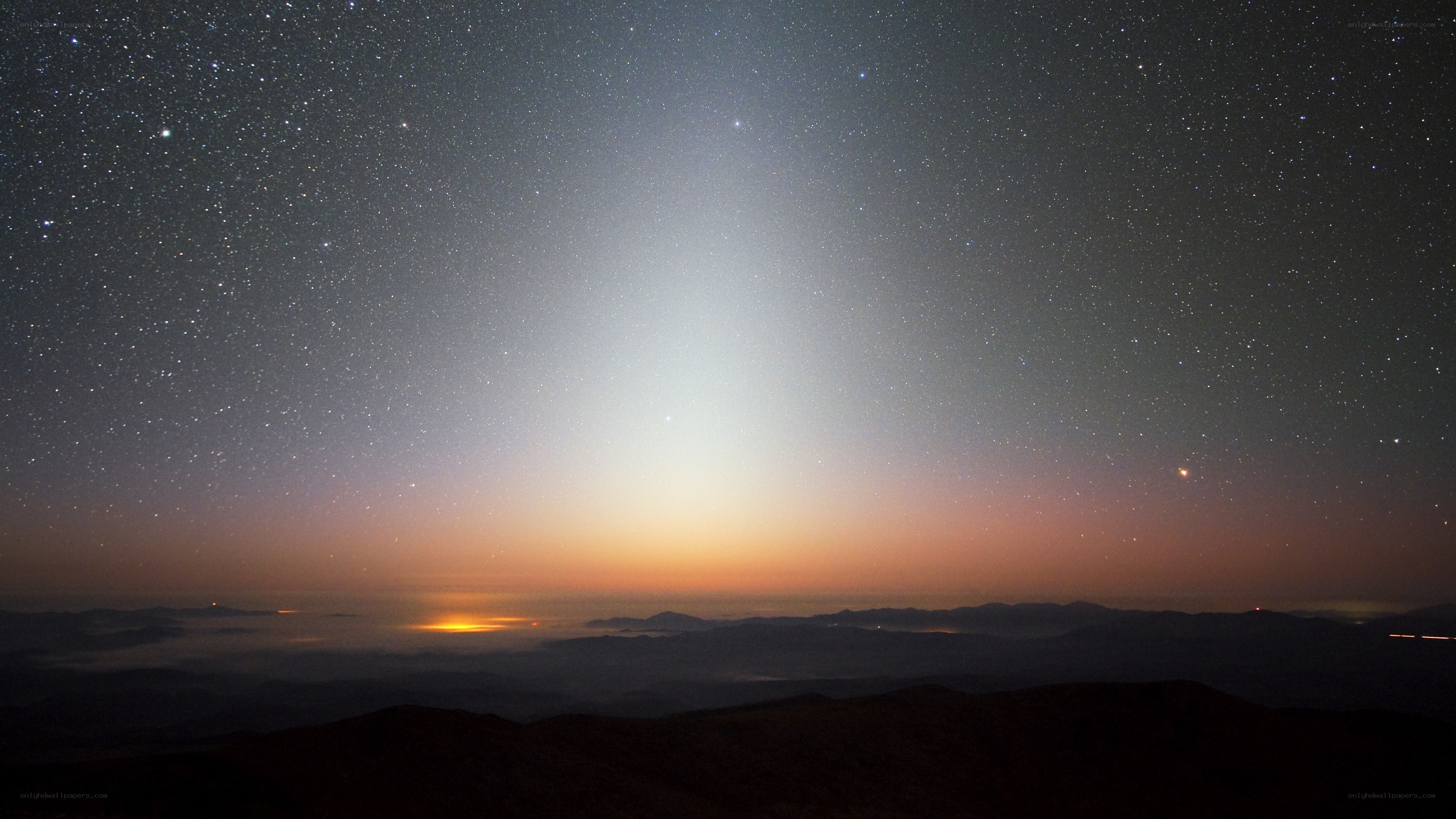 Starlit sky over mountain peaks