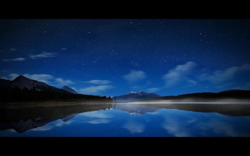 Starry night over a calm lake