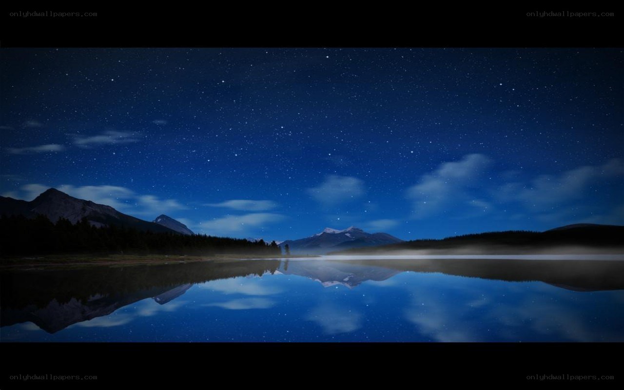 Starry night over a calm lake