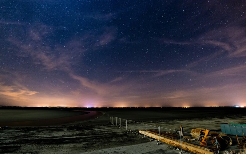 Starry night over a coastal area