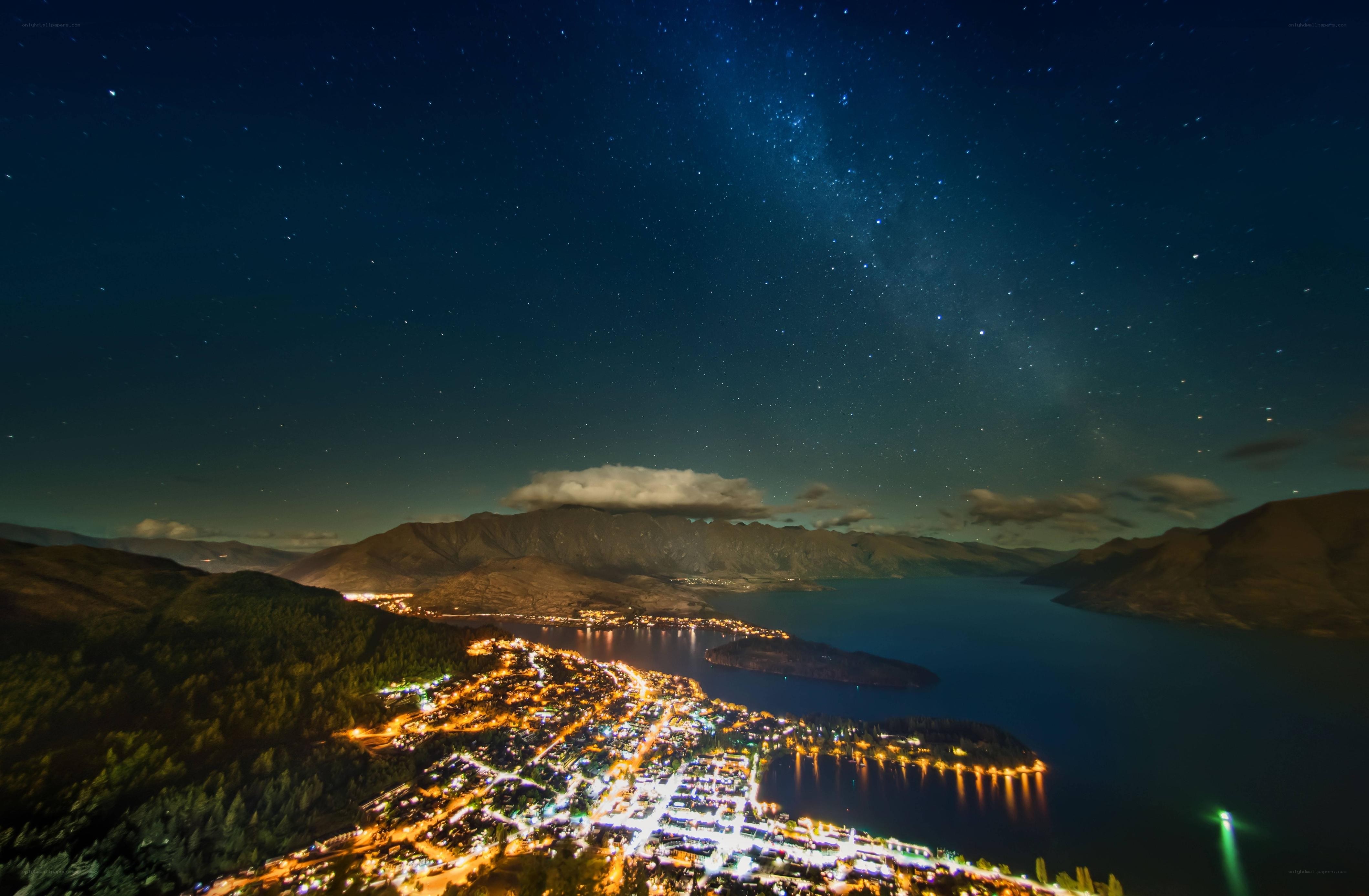 Starry night over a lakeside town
