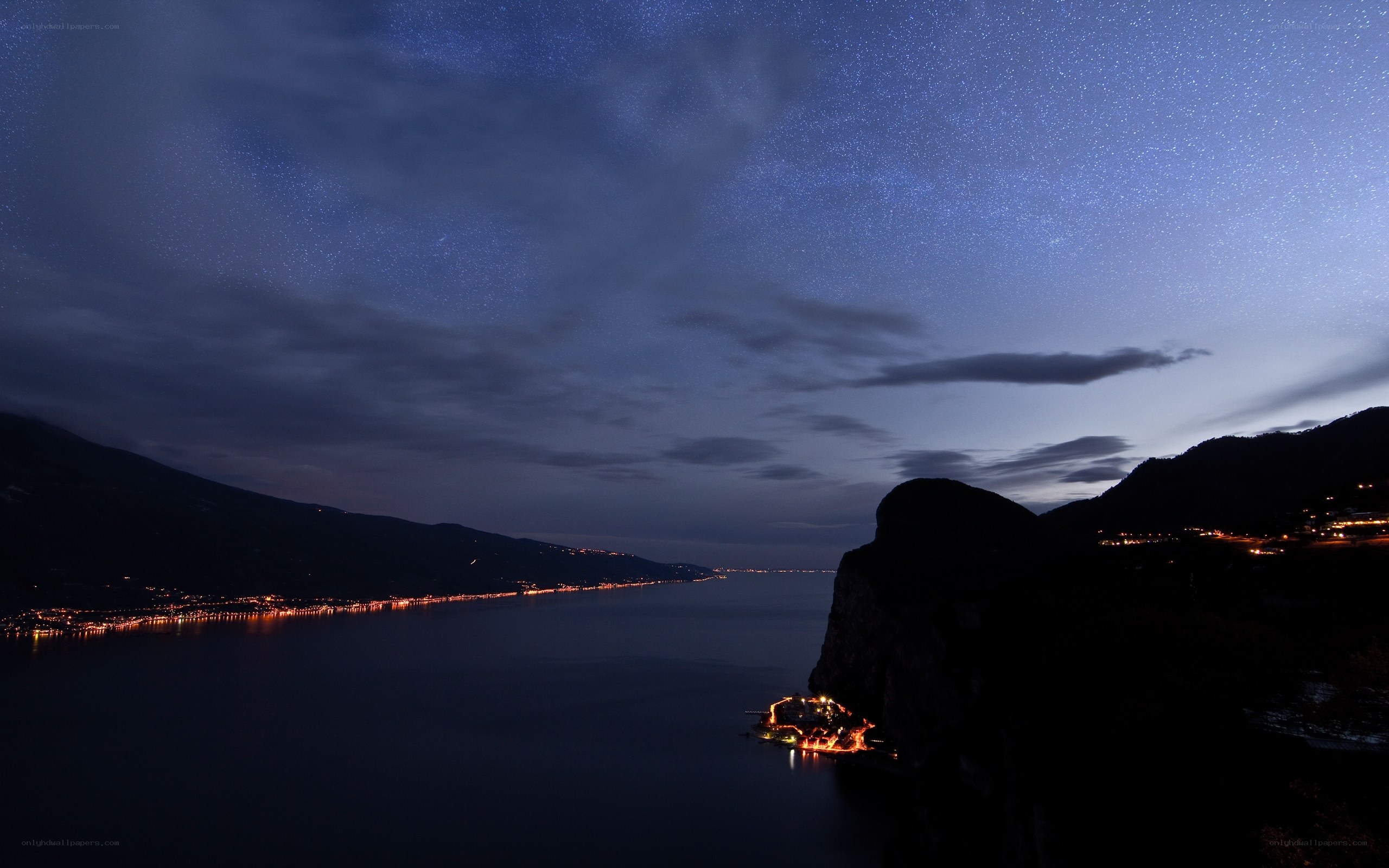 Starry night over a lakeside town
