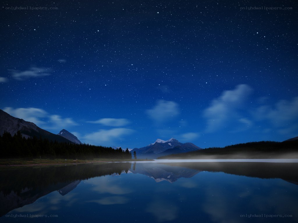 Starry night over a mountain lake