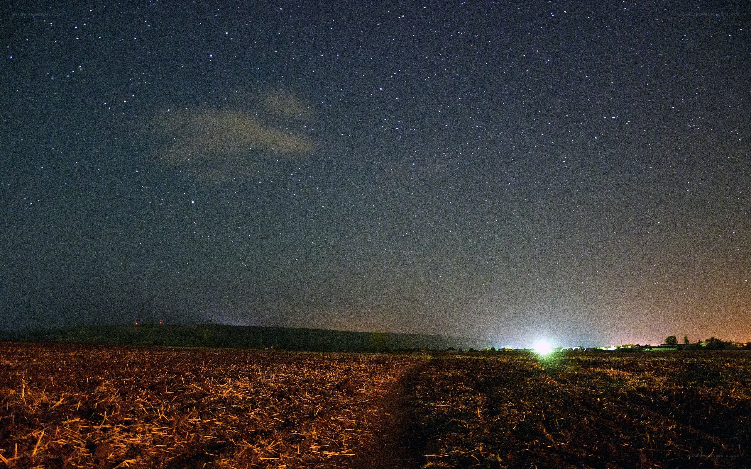 Starry night over a plowed field