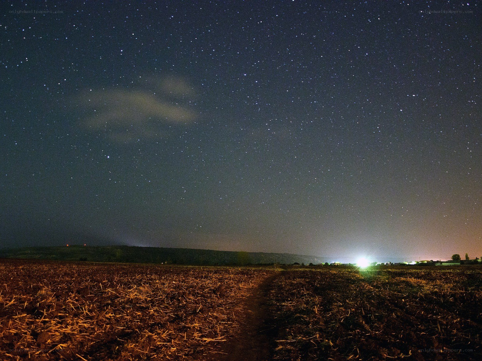 Starry night over a plowed field
