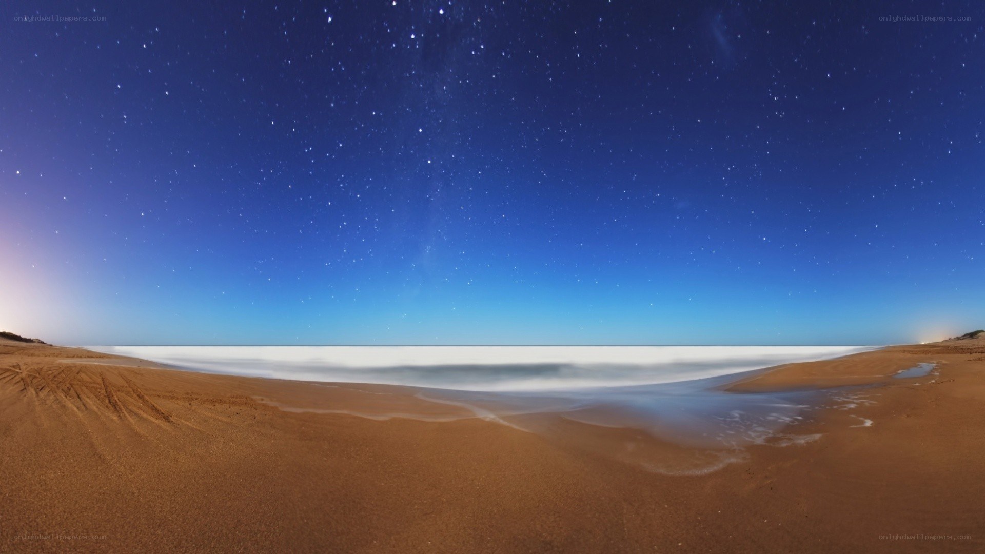 Starry night over a sandy beach