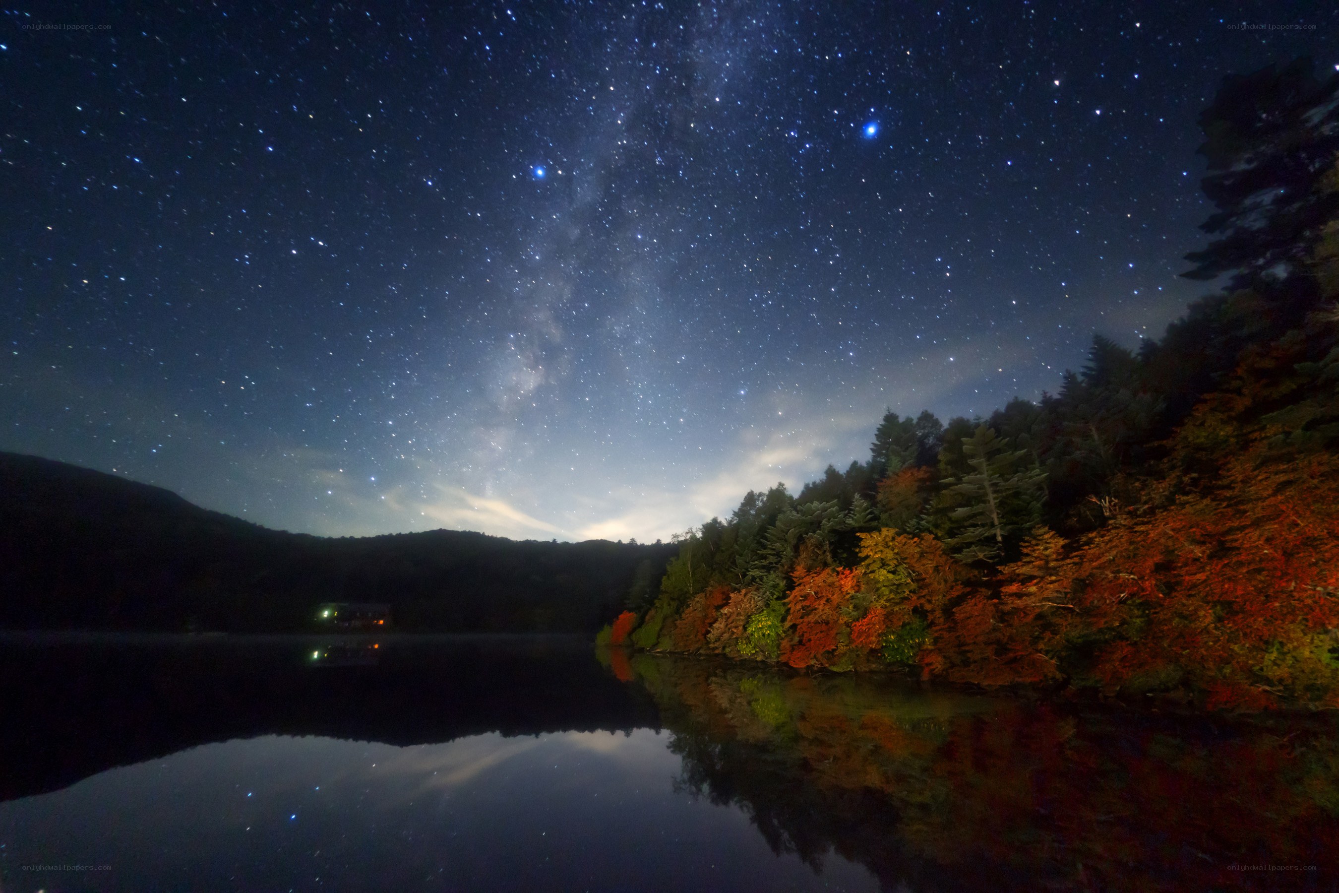 Starry night over autumn lake