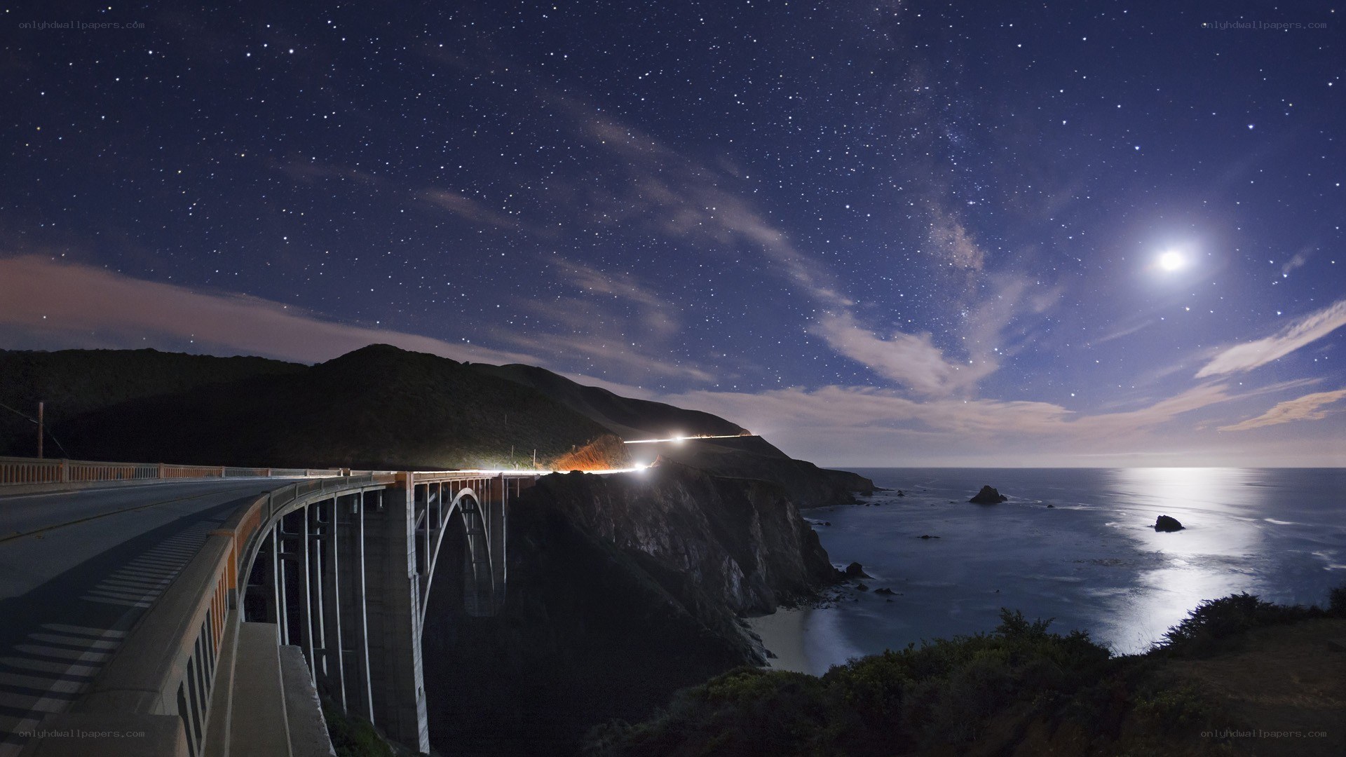 Starry night over coastal bridge