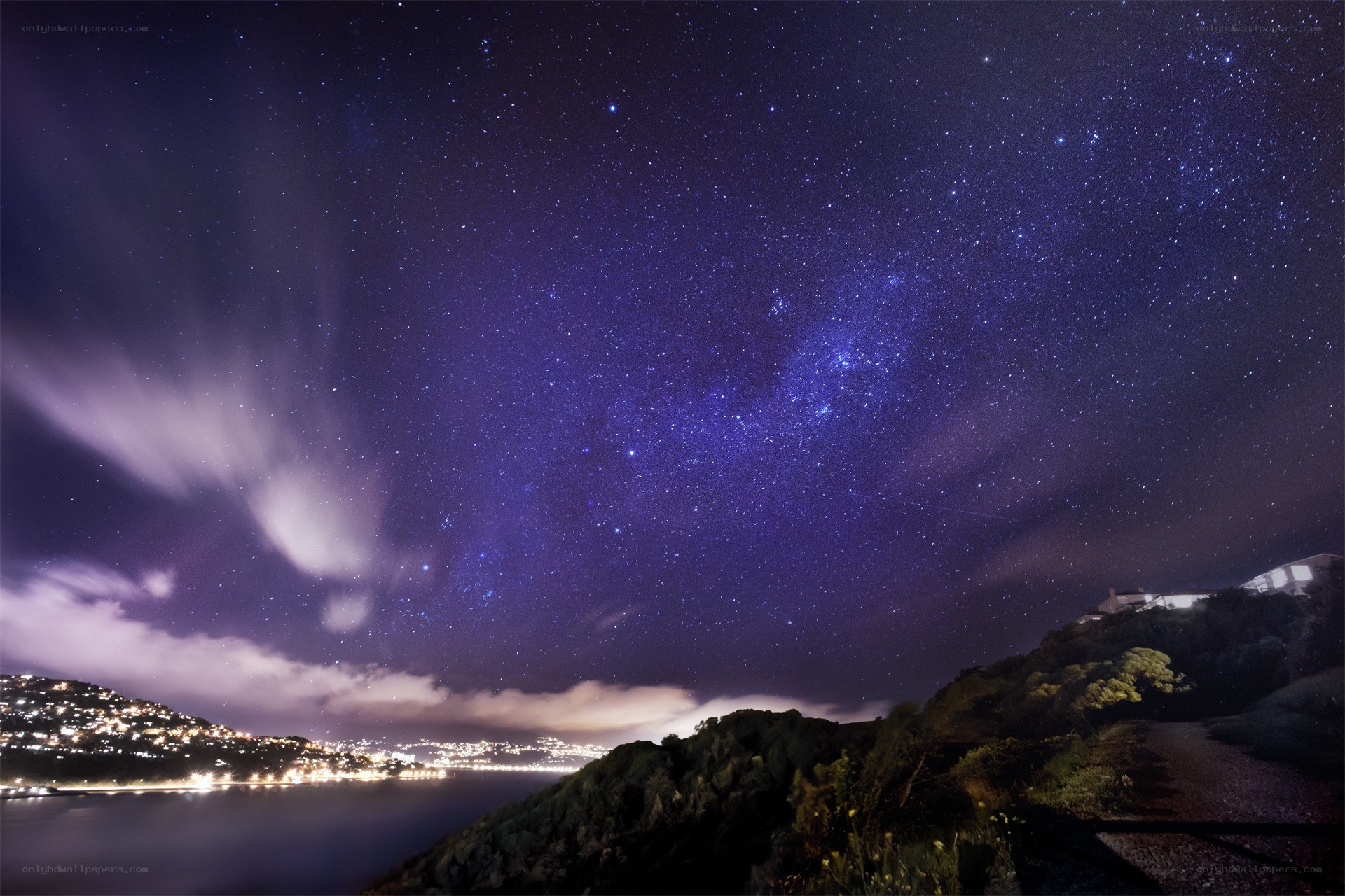 Starry night over coastal town