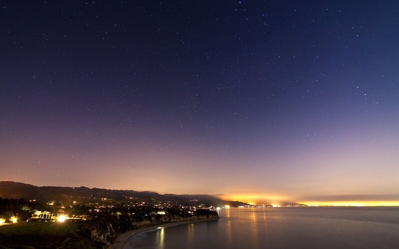 Starry night over coastal town