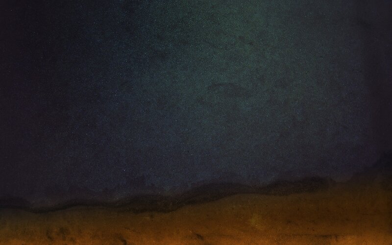 Starry night over dark landscape