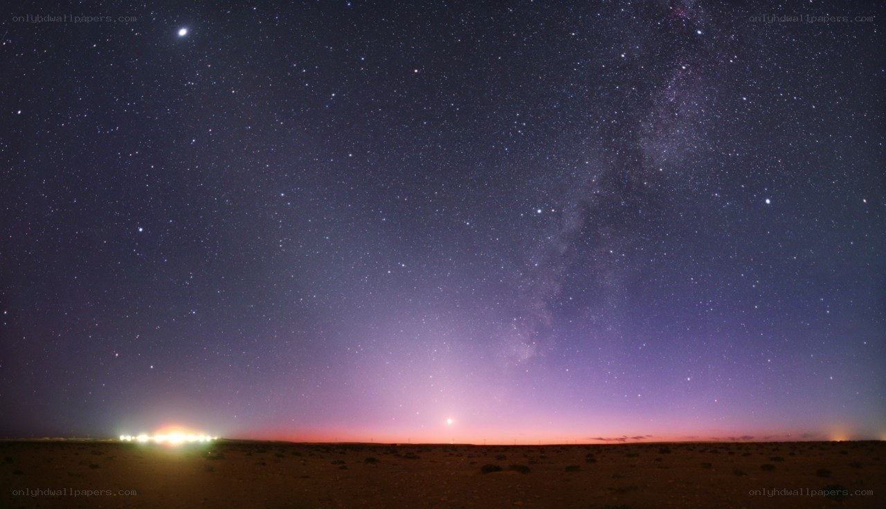Starry night over desert landscape