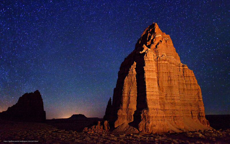 Starry night over desert rock formations