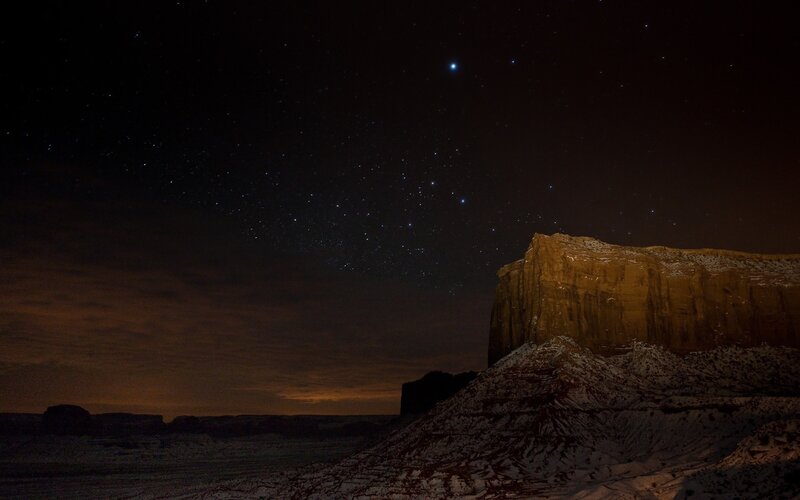 Starry night over desert rock formations