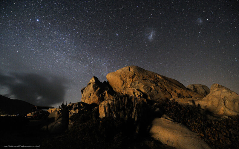 Starry night over desert rocks