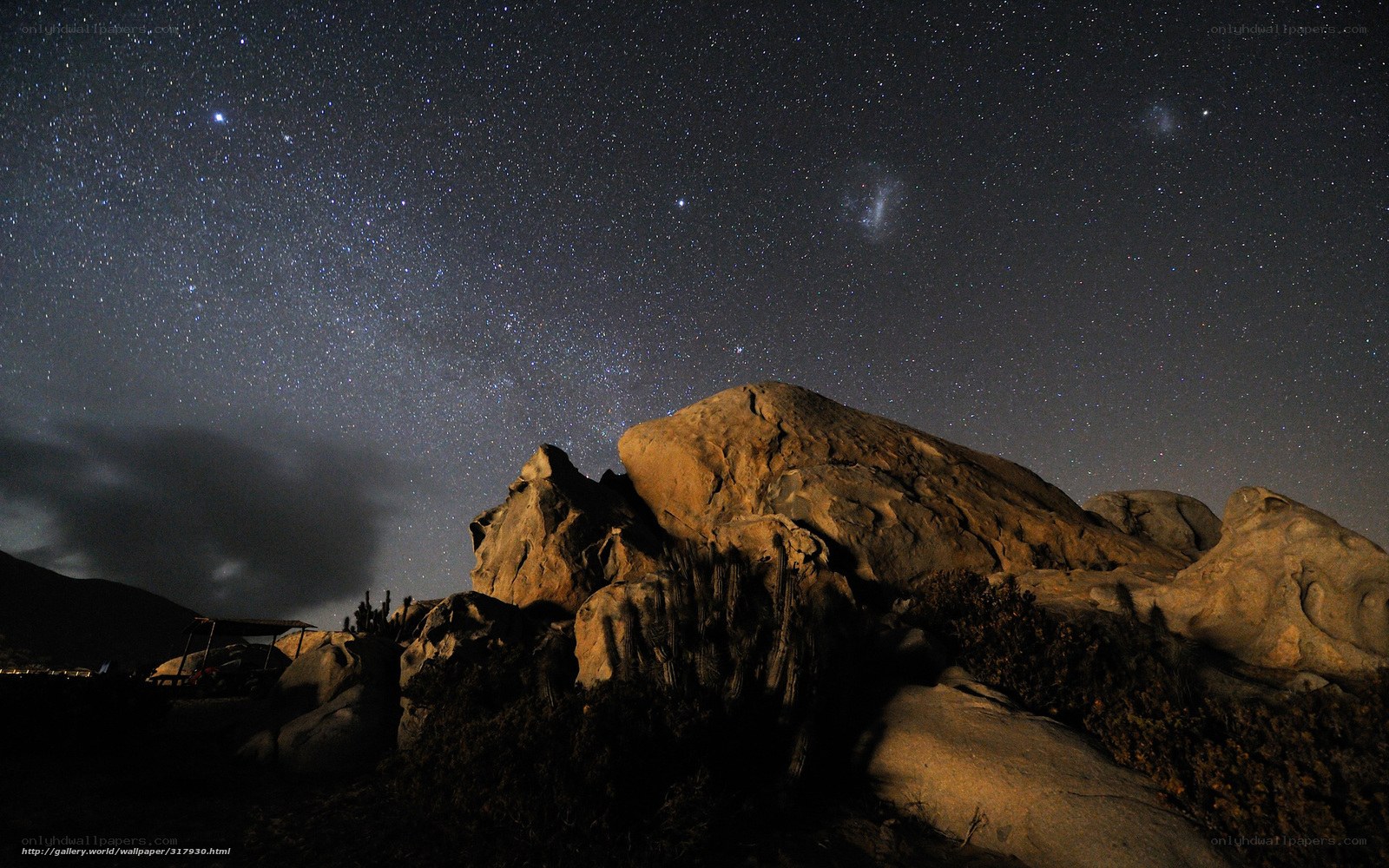 Starry night over desert rocks