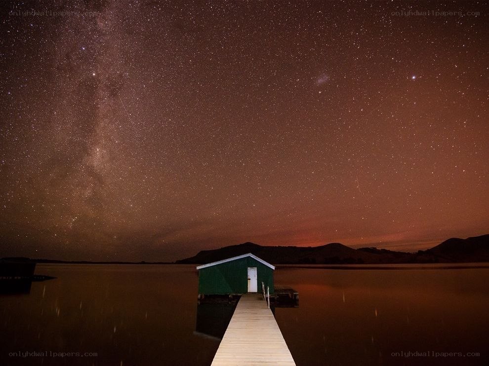 Starry night over lake house