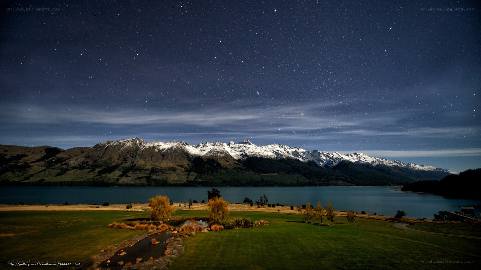 Starry night over mountain lake