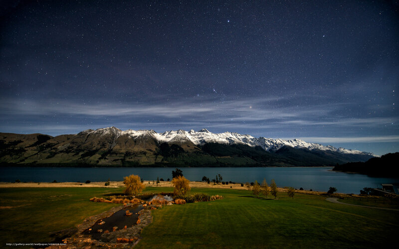 Starry night over mountain lake
