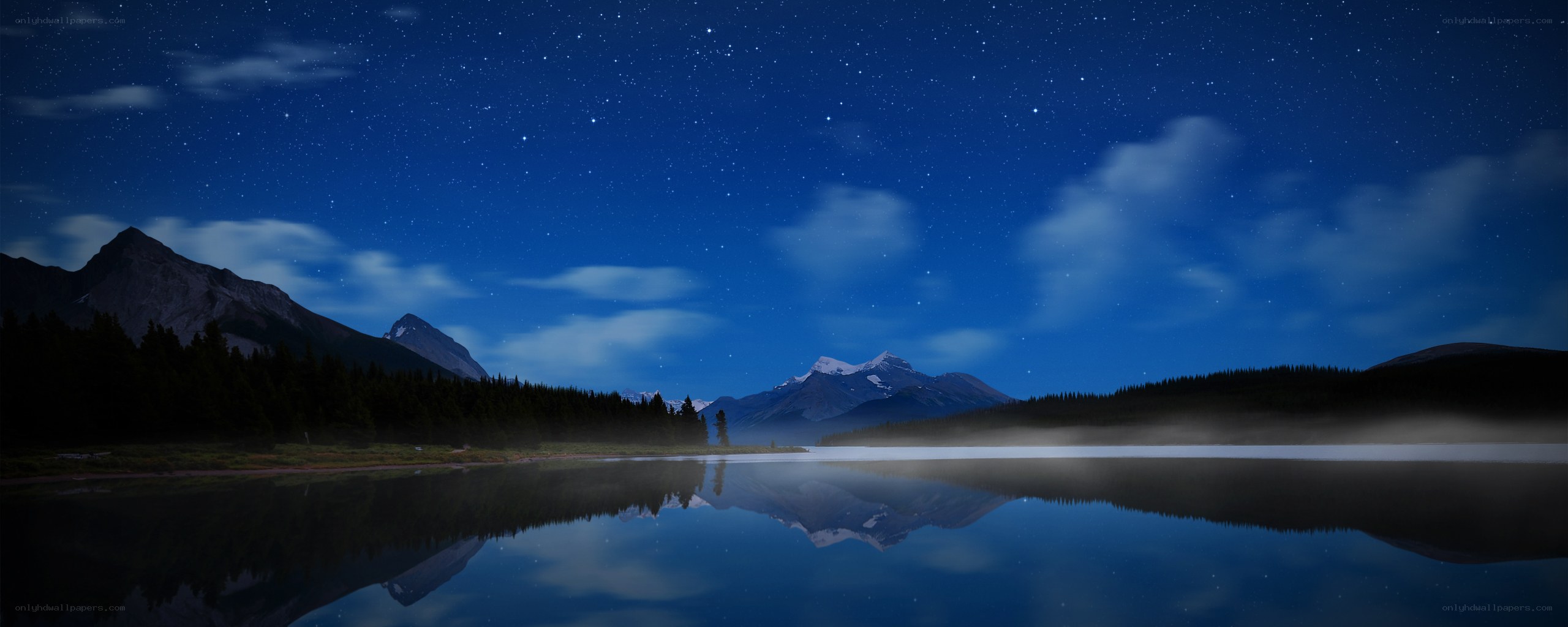 Starry night over mountain lake