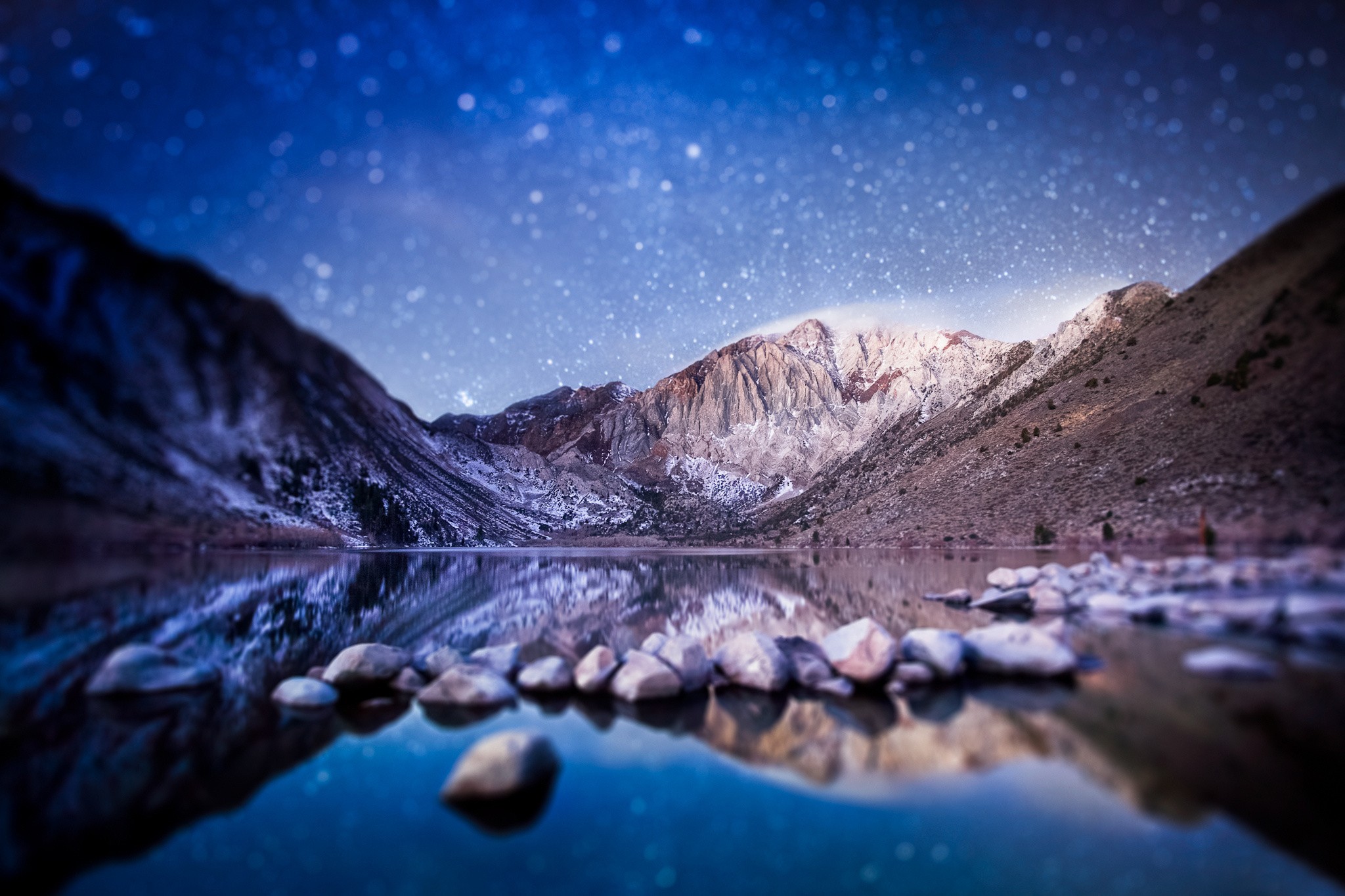 Starry night over mountain lake