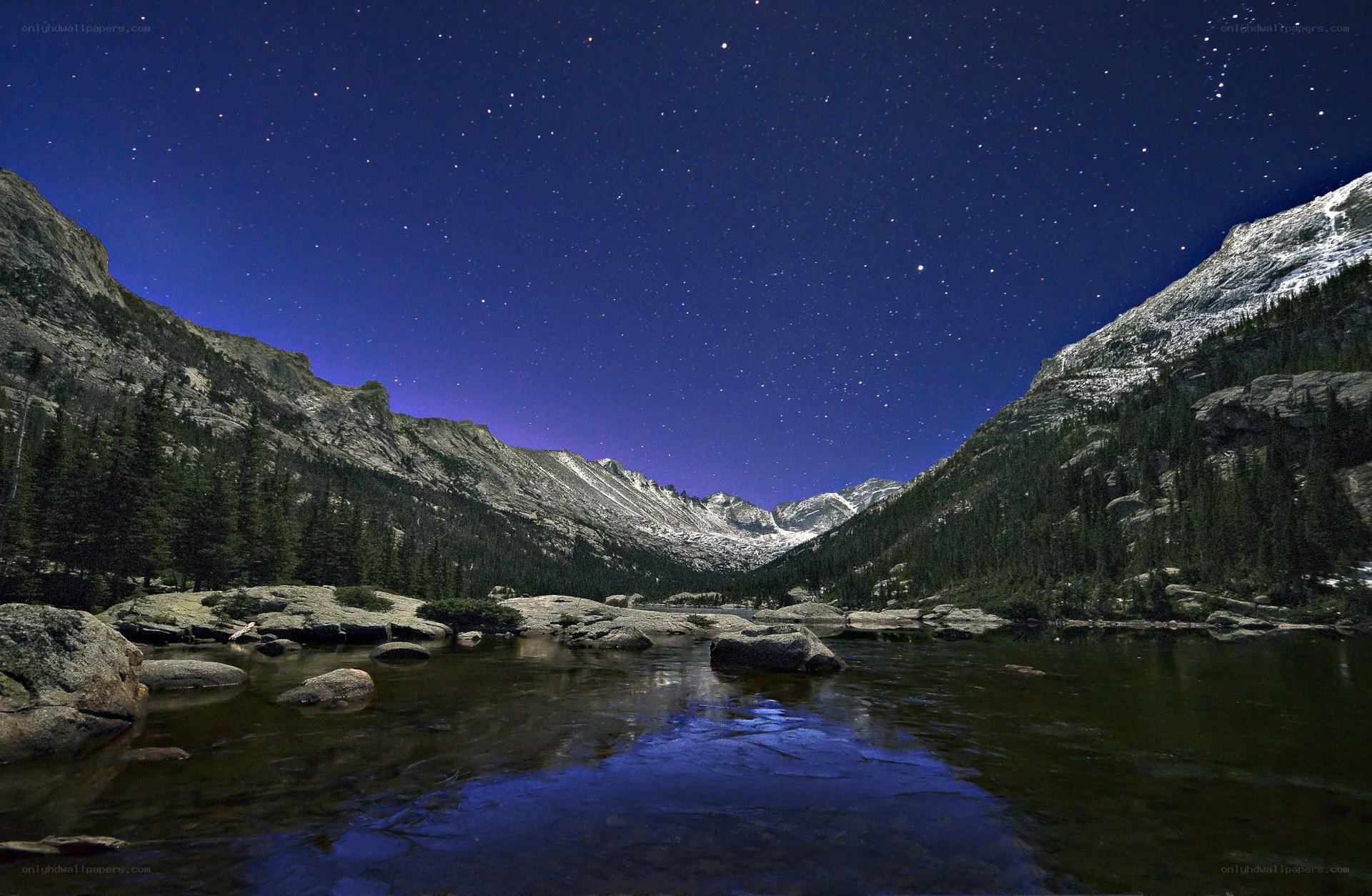 Starry night over mountain lake