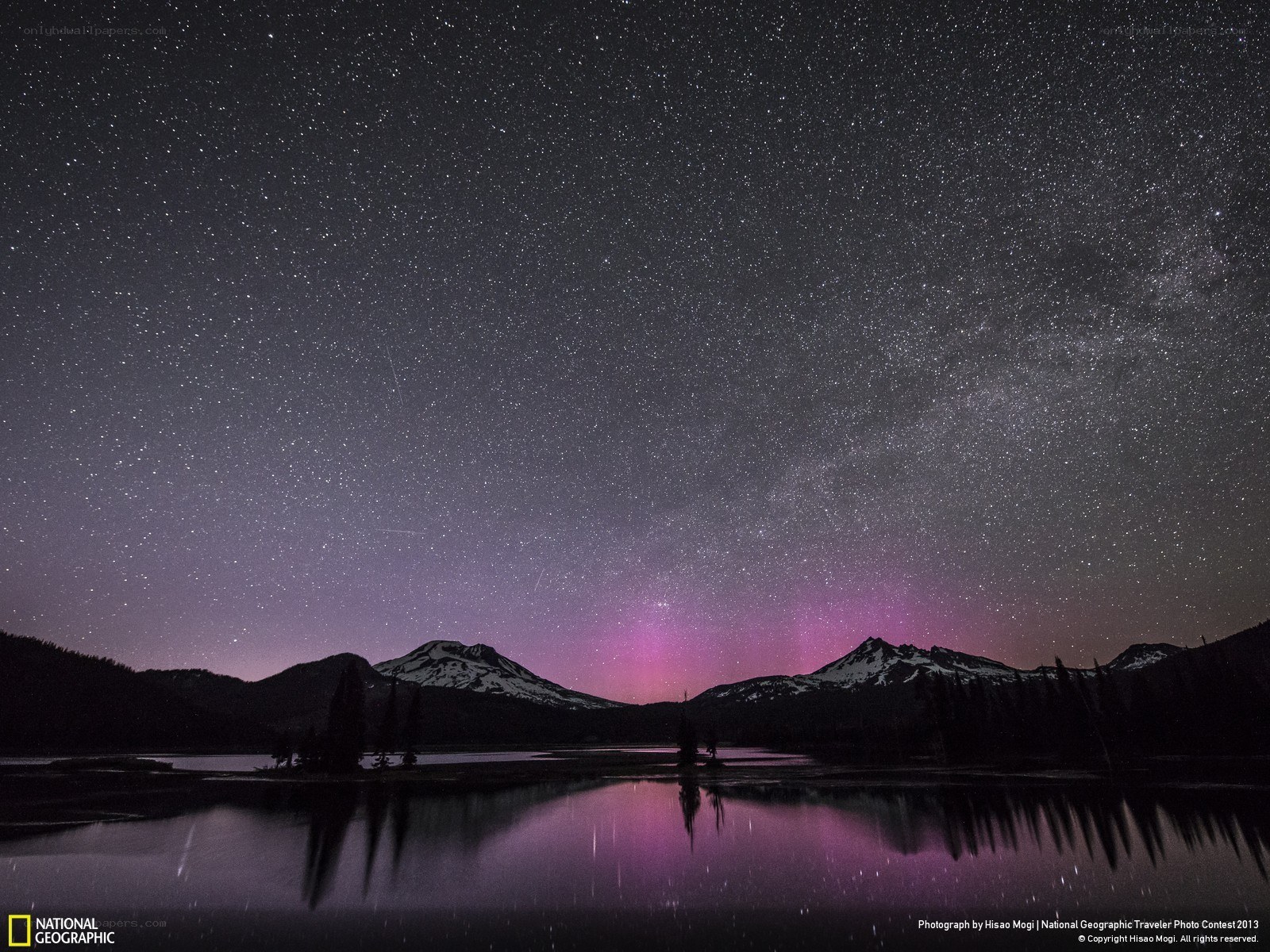 Starry night over mountain lake