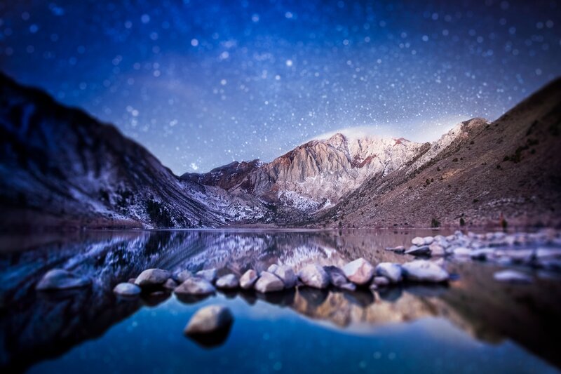 Starry night over mountain lake