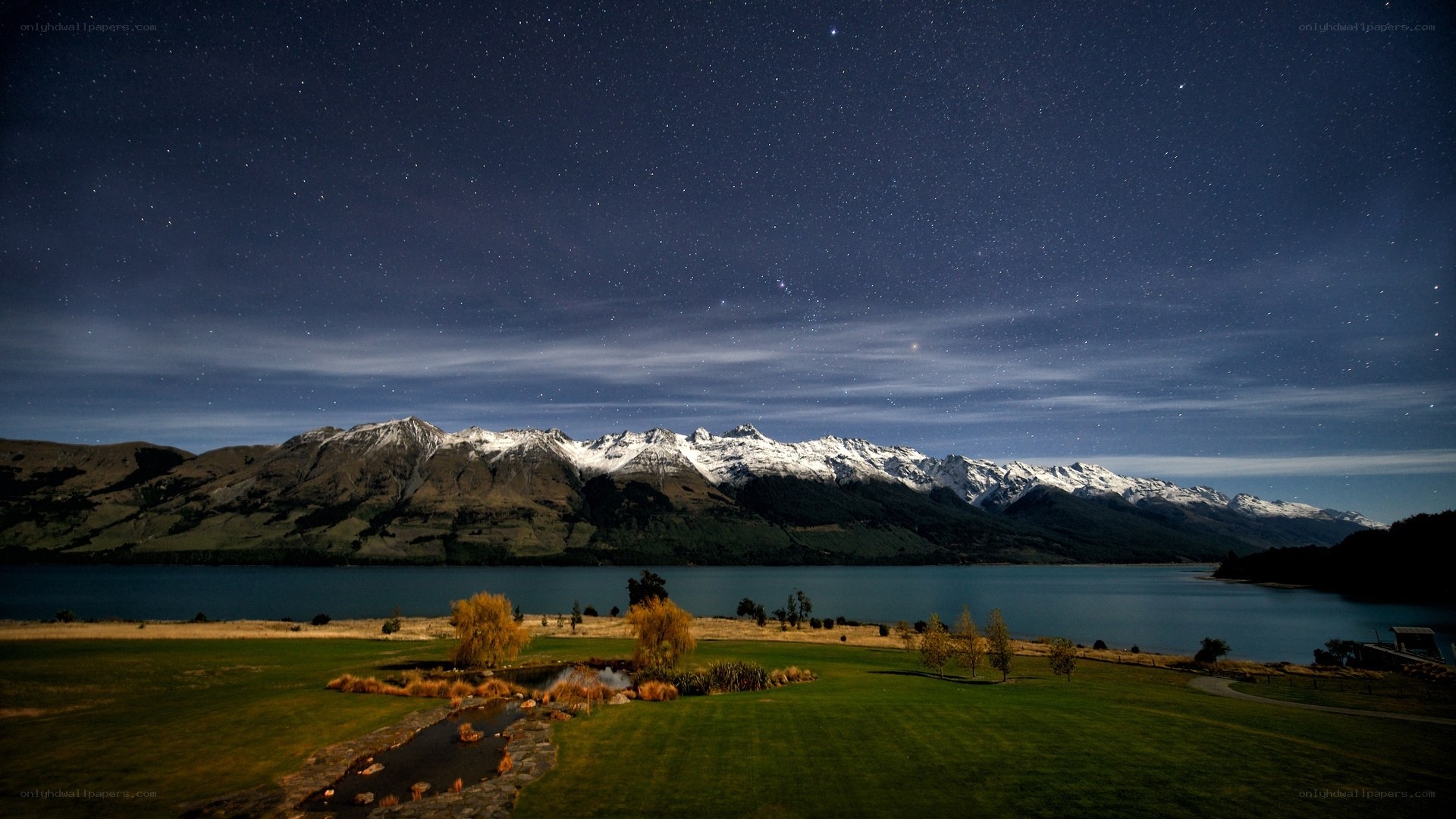 Starry night over mountain lake